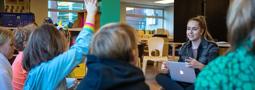 An SPU student works with elementary school children